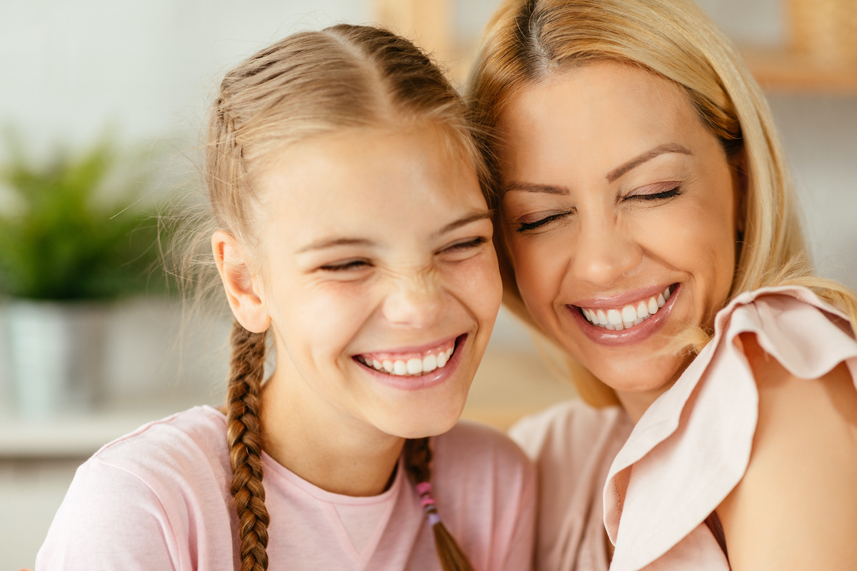 mother and daughter smiling