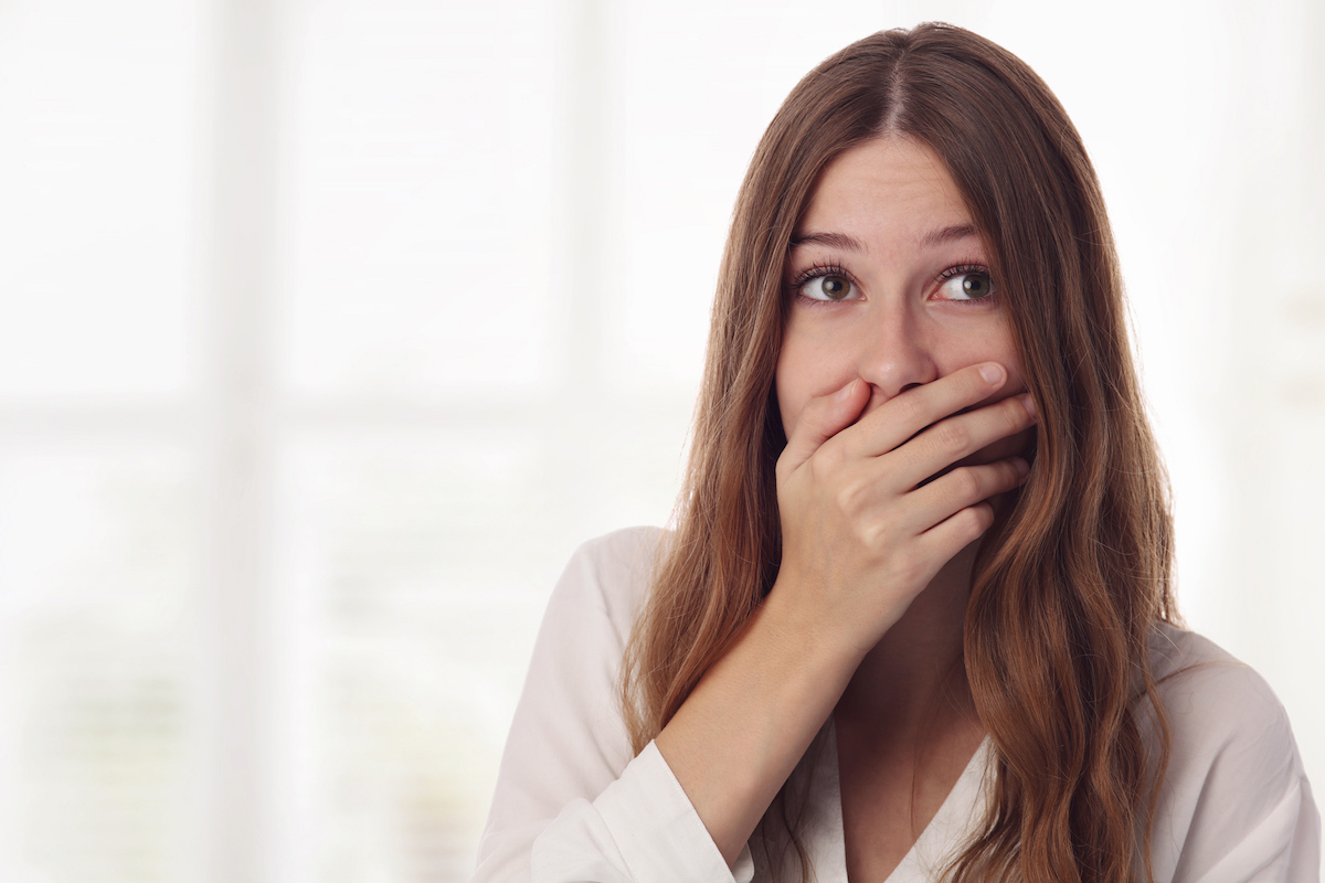Embarresed woman holding mouth leaky bladder